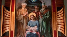 Utsnitt fra altertavla i Øvre Vang kirke. Altertavla er malt i 1933 av Ola Mathias Abrahamsson og forestiller kongenes tilbedelse av Jesusbarnet. Bildet er spesielt blant annet ved at bare Maria har stråleglans rundt hodet, men ikke Jesusbarnet. Det siste skyldes visstnok at kunstneren ble pålagt å gjøre om på bildet etter en klage.