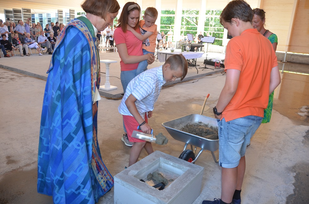Grunnsteinen sementeres ned av Jonas Ravnås Lundbakk og Trym Kleven. Foto: Kåre Steinsvik