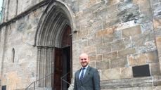 Menighetsrådsleder Christian Nesset foran Domkirken hvor fraværet av stillas vitner om fremgang i arbeidet med å renovere kirken. (Foto:Eirik B. Minde)