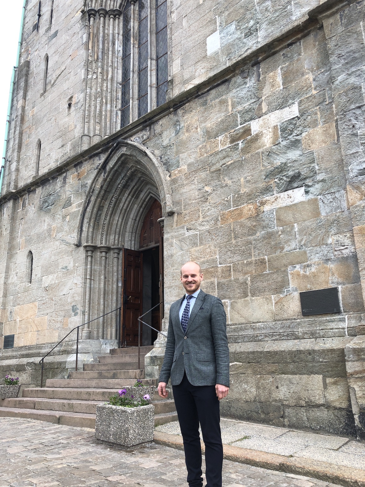 Menighetsrådsleder Christian Nesset foran Domkirken hvor fraværet av stillas vitner om fremgang i arbeidet med å renovere kirken. (Foto:Eirik B. Minde)
