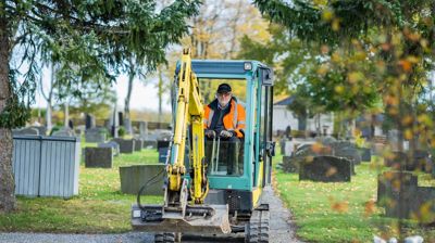 Illustrasjonsbilde: Bildet viser gravemaskin i arbeid på en gravplass. "Foto: Torstein Kiserud / Den norske kirke"