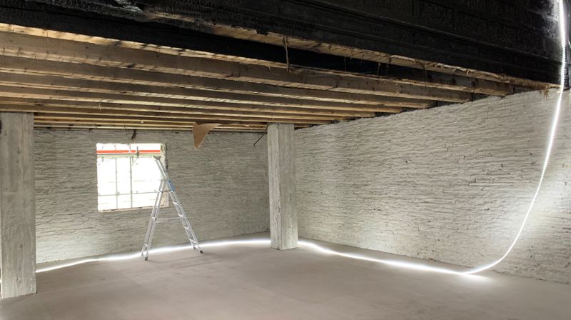 I kyrkjerommet er murpuss og treverk fjerna og det er lagt på midlertidig golvdet er