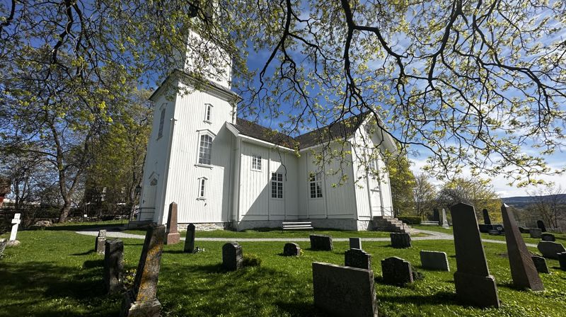 Nes kirke i klar vårsol og grønt (foto: Eli-Kristin Sjøli Ulsund).
