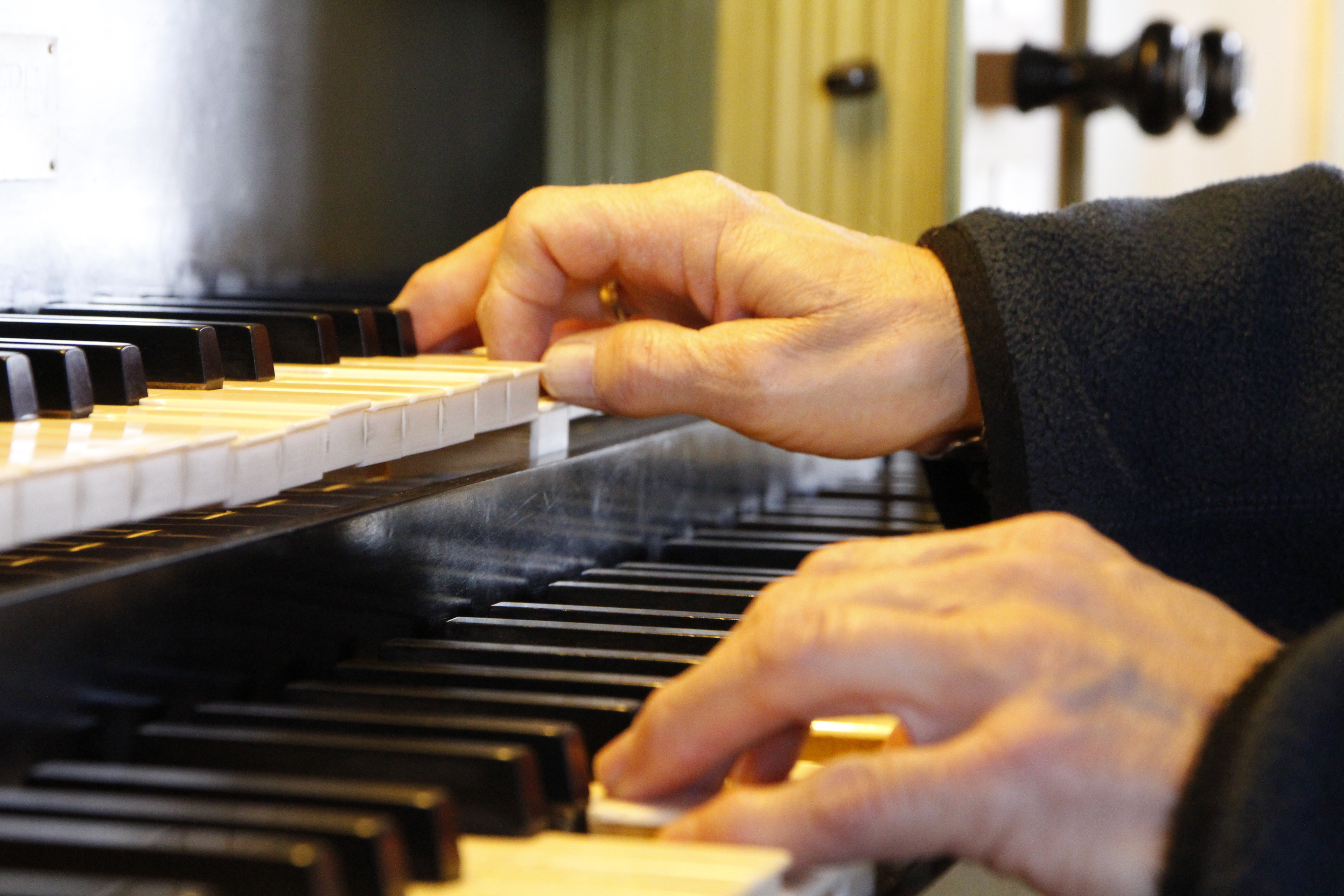 To hender spiller på et orgel, høyre hånd på den øverste klaviaturen og venstre på den nederste