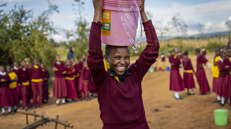 Dette er 15 år gamle Deodata Julius Anii. Etter at landsbyen hun bor i fikk vann er livet hennes blitt mye bedre og hun kan fokusere på skolearbeidet. Foto: Kirkens Nødhjelp
