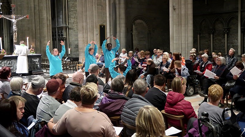 Medlemmer av Kor Artig viser bevegelser til forbønn.  Foto hentet fra kirken.no/nidaros